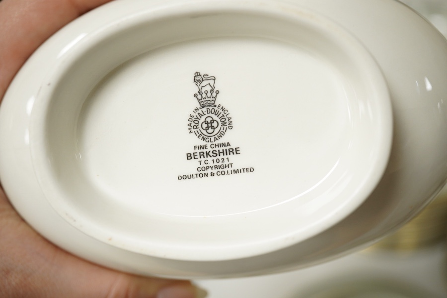 A Royal Doulton Berkshire pattern part dinner service to include tureens, twin handled cups and oval platters, largest 33cm wide. Condition - mostly good